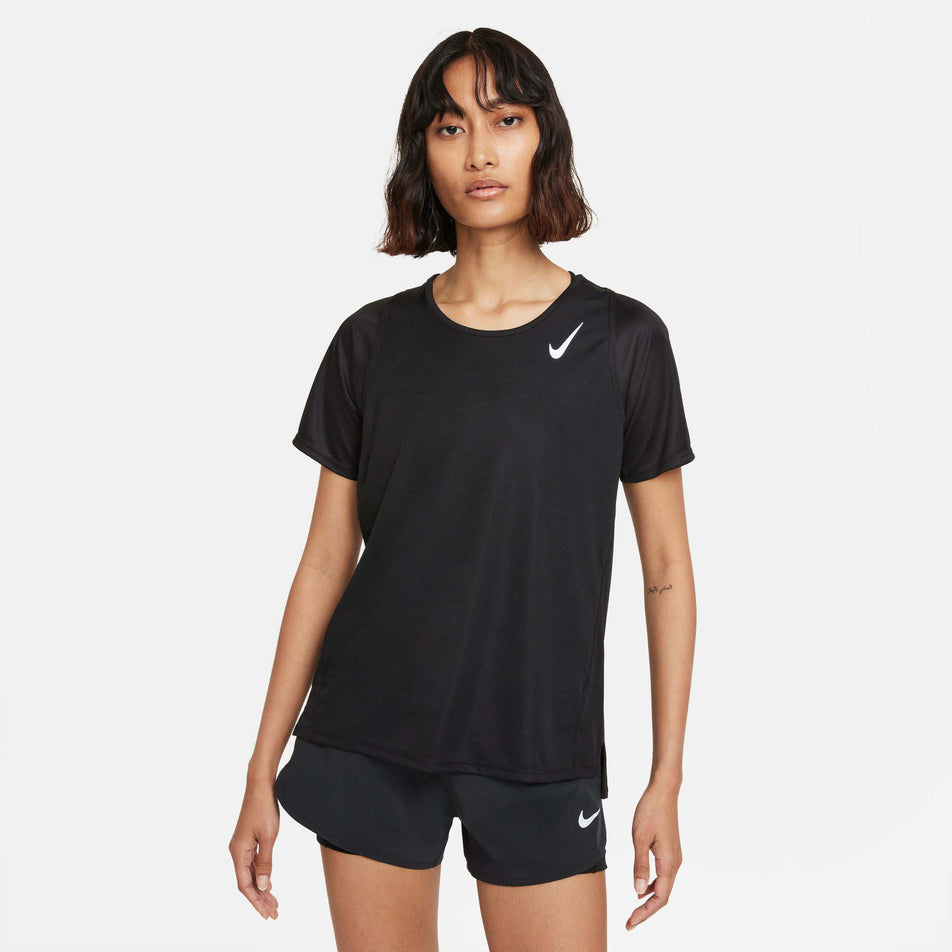 Front view of a model wearing a Nike Women's Dri-FIT Race Short-Sleeve Running Top in the Black/Reflective Silv colourway. Model is also wearing black Nike shorts. (8215857397922)