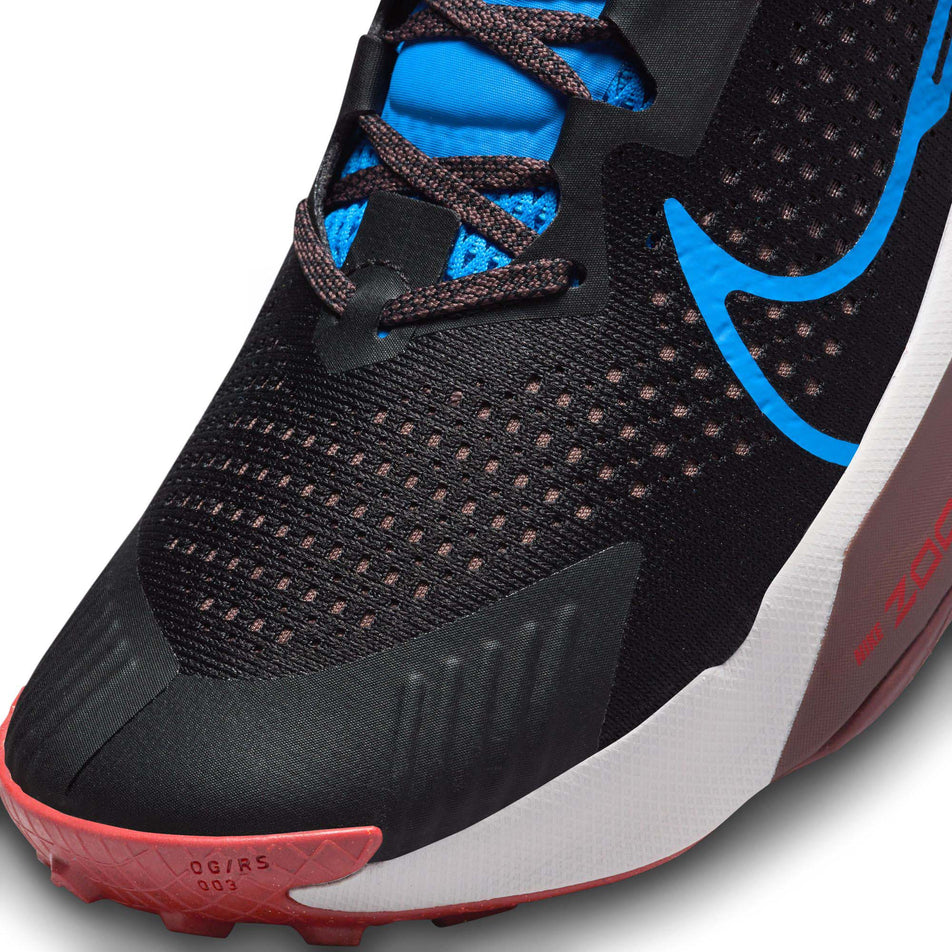 Lateral side of the toe box on the left shoe from a pair of Nike Men's Zegama Trail Running Shoes in the Black/LT Photo Blue-Vivid Sulfur colourway (7970895724706)