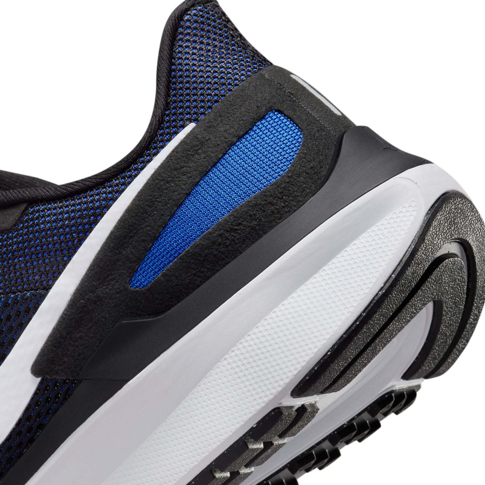 Lateral side of the back of the left shoe from a pair of Nike Men's Structure 25 Road Running Shoes in the Black/White-Racer Blue-Sundial colourway (8025956745378)