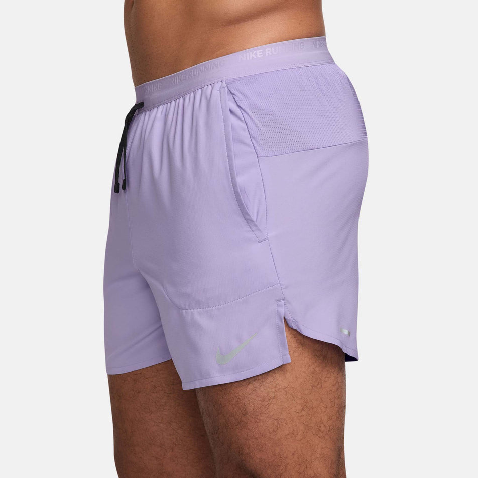 Side view of a model wearing the Nike Men's Dri-FIT Stride 5