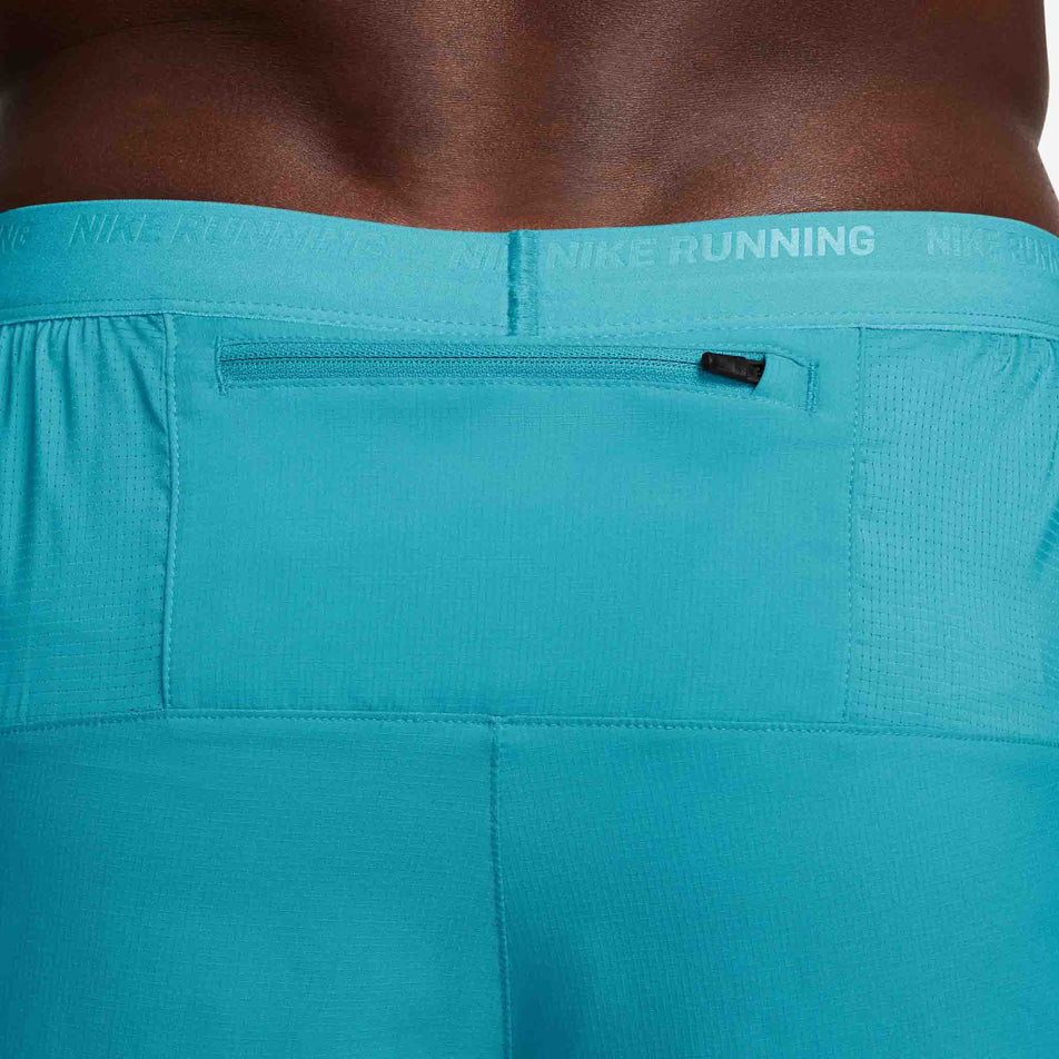 Close-up view of the zipped back pocket on a pair of Nike Men's Stride Dri-FIT 5