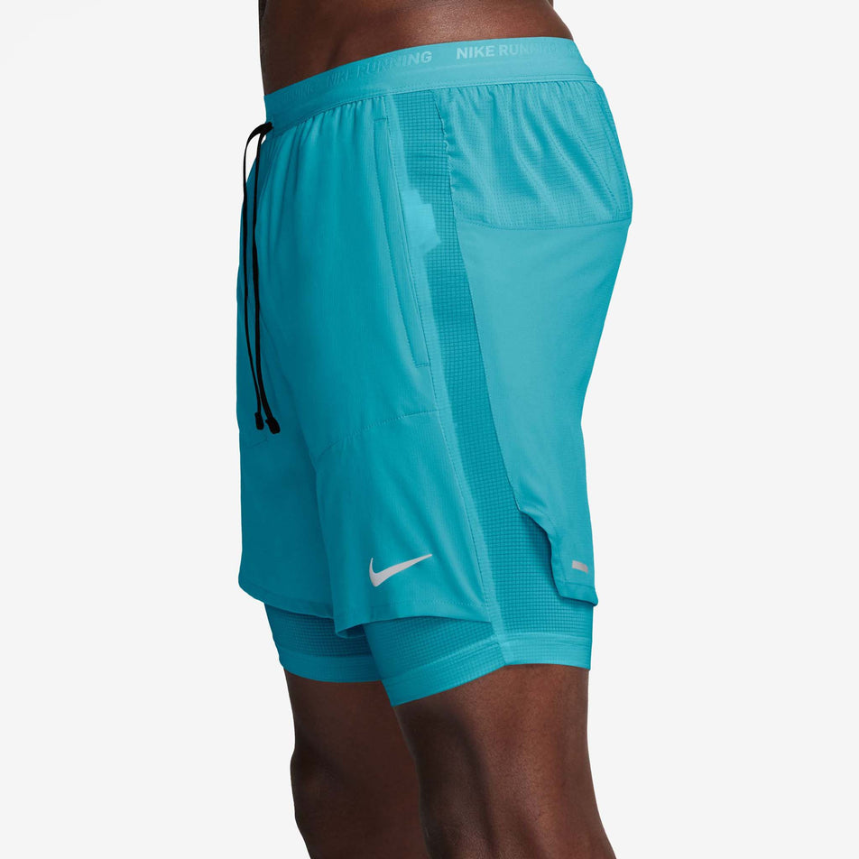 Side view of a model wearing the Nike Men's Stride Dri-FIT 5