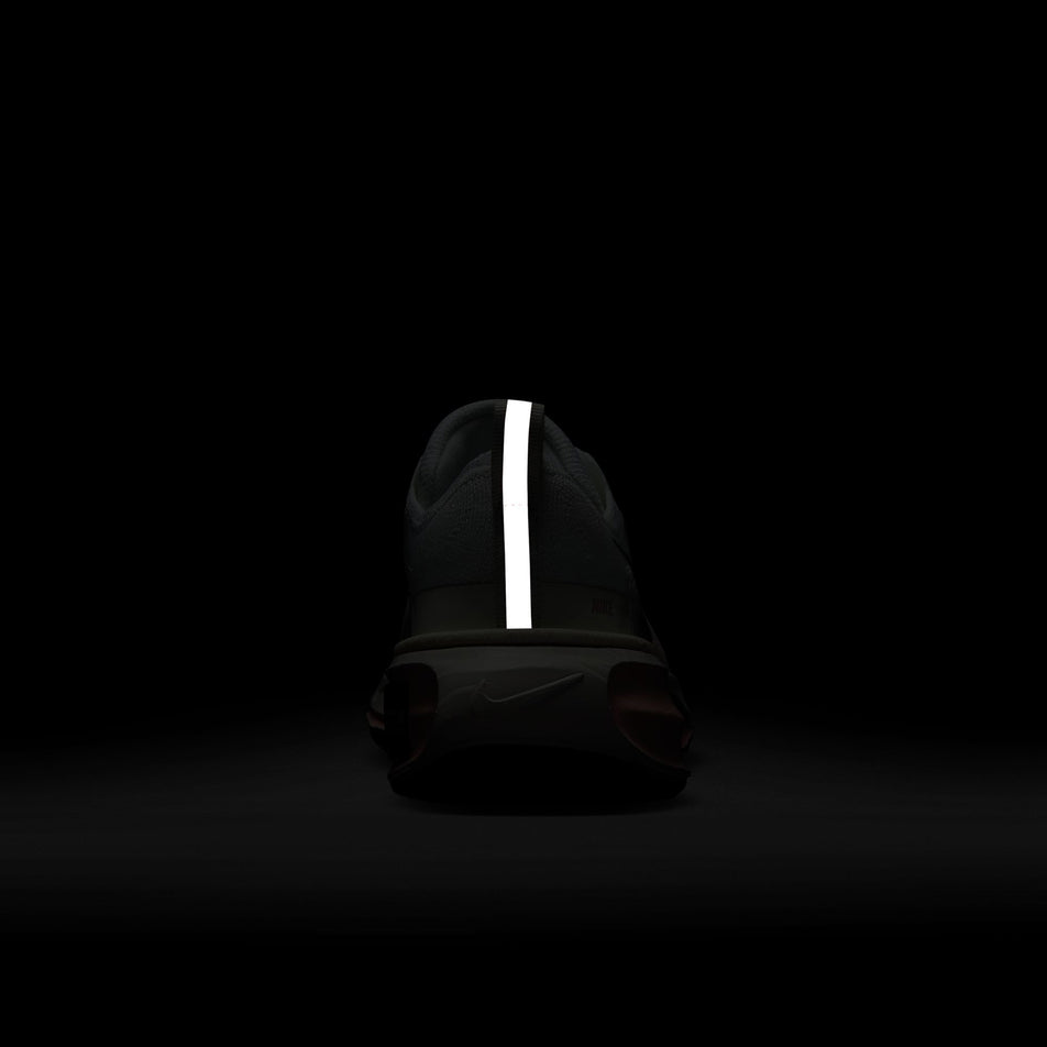 The reflective strip on the back of the right shoe from a pair of Nike Women's Invincible 3 Road Running Shoes in the White/Black-Atmosphere-Blue Tint colourway.(8615483375778)