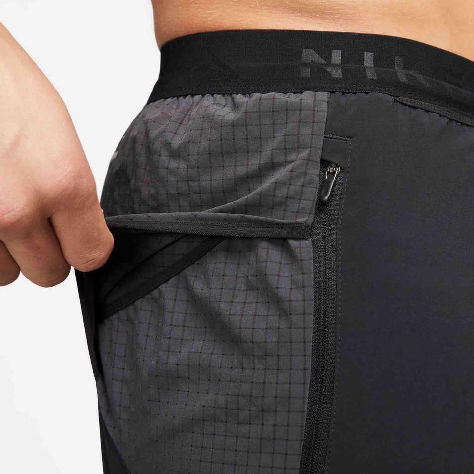 Close-up of the drop-in pocket on the right side of a pair of Nike Men's Dri-FIT Trail Second Sunrise 5