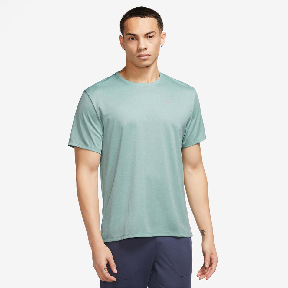 Front view of a model wearing a Nike Men's Miler Dri-FIT UV Short-Sleeve Running Top in the  Mineral/Jade Ice/HTR/Reflective Silv colourway (7980005261474)