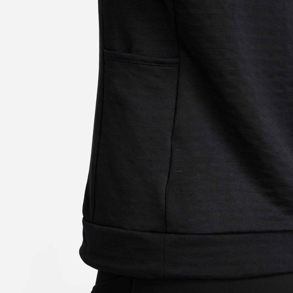 Close-up view of a pocket on the side of the Nike Women's Swift Element Therma-FIT Turtleneck Running Top in the Black/Reflective Silver colourway. (8497637752994)