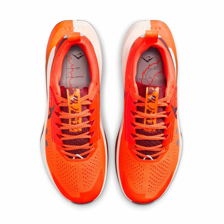 The uppers of a pair of Nike Women's Zegama Trail 2 Trail Running Shoes in the Hyper Crimson/Dark Team Res-Glacier Blue colourway. (8725423882402)