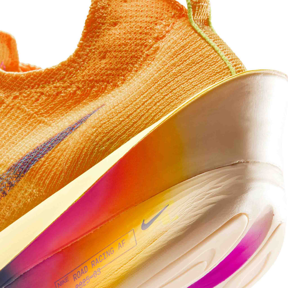 Close-up view of the rearfoot section of the left shoe from a pair of Nike Men's Alphafly 3 Running Shoes in the Laser Orange/Indigo Burst-Citron Pulse colourway.