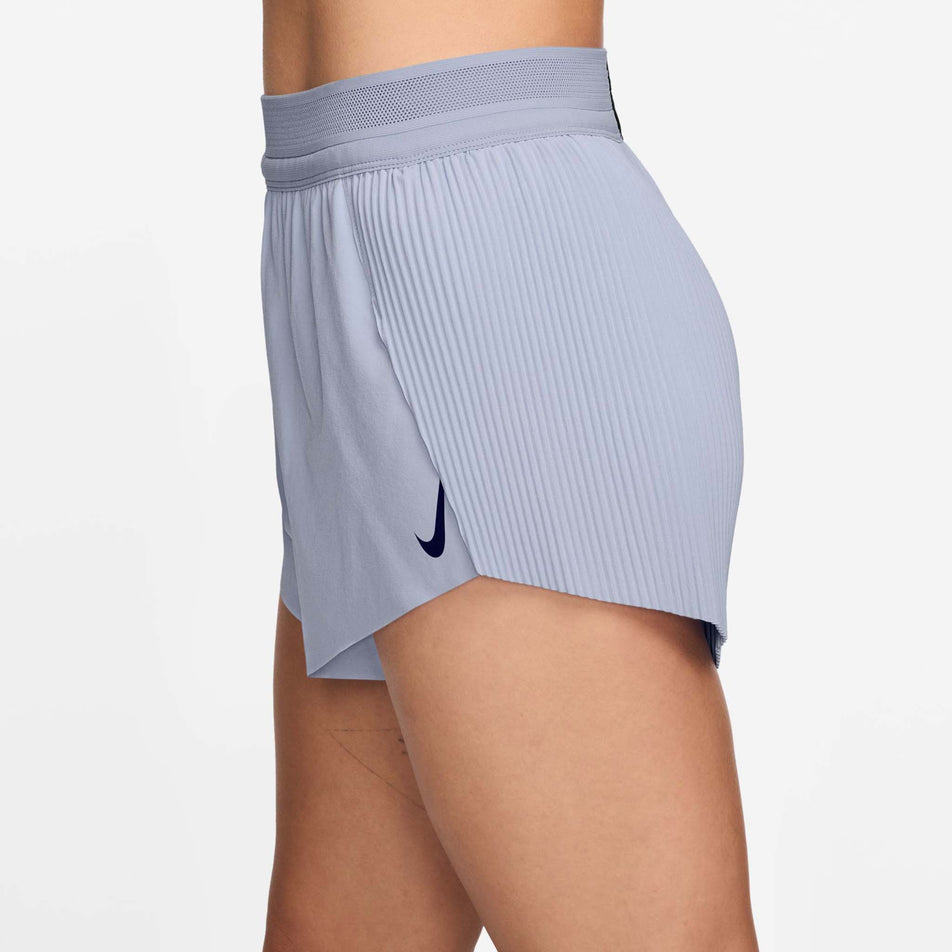 Side view of a model wearing a pair of Nike Women's AeroSwift Dri-FIT ADV Mid-Rise Brief-Lined 3