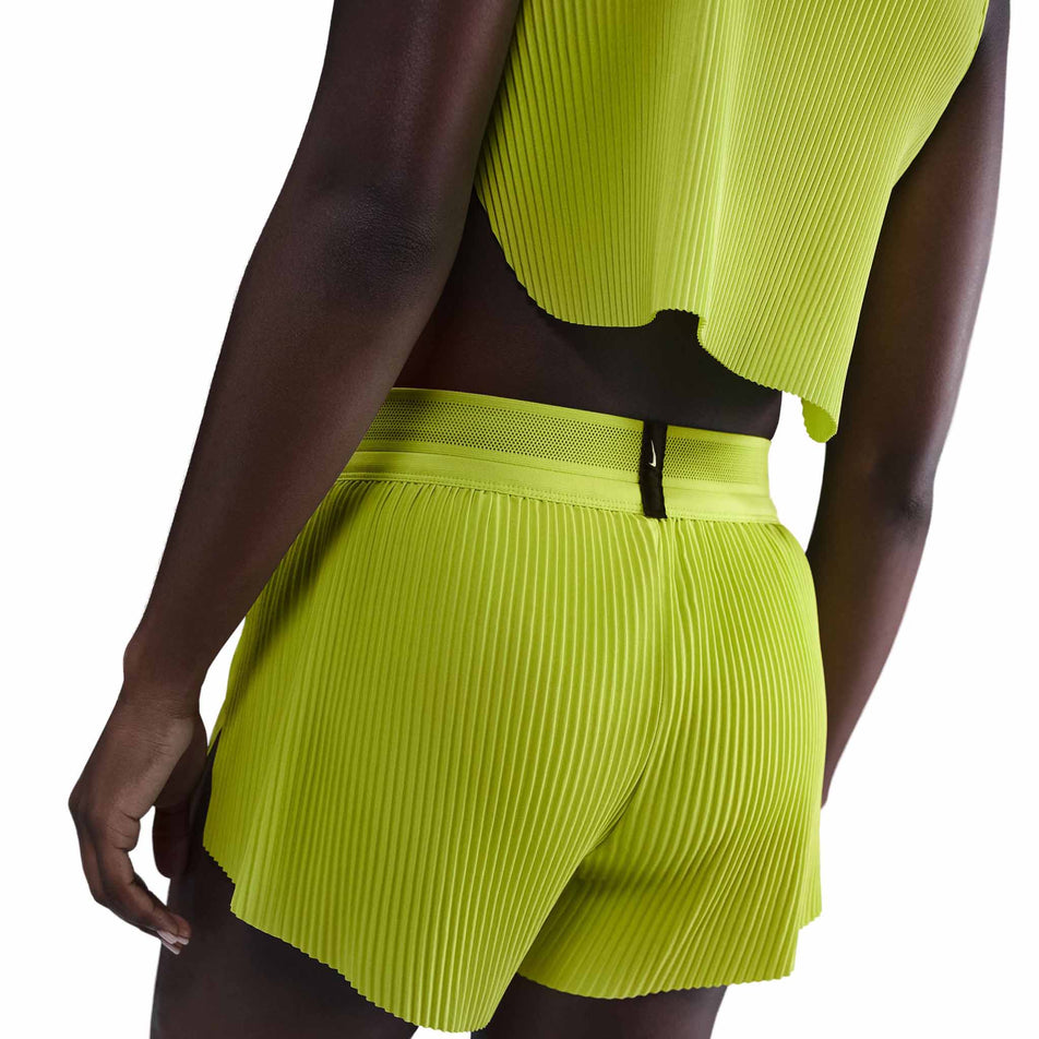Back view of a model wearing the Nike Women's AeroSwift Dri-FIT ADV Mid-Rise Brief-Lined 3