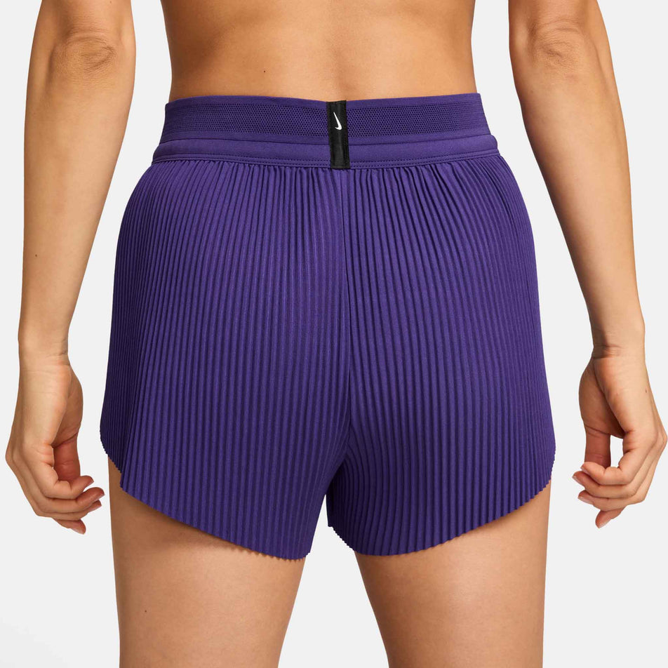 Back view of a model wearing the Nike Women's AeroSwift Dri-FIT ADV Mid-Rise Brief-Lined 3