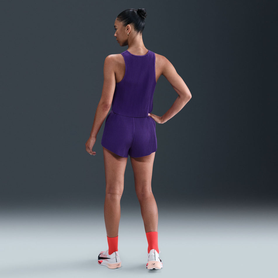 Back view of a model wearing the Nike Women's AeroSwift Dri-FIT ADV Mid-Rise Brief-Lined 3