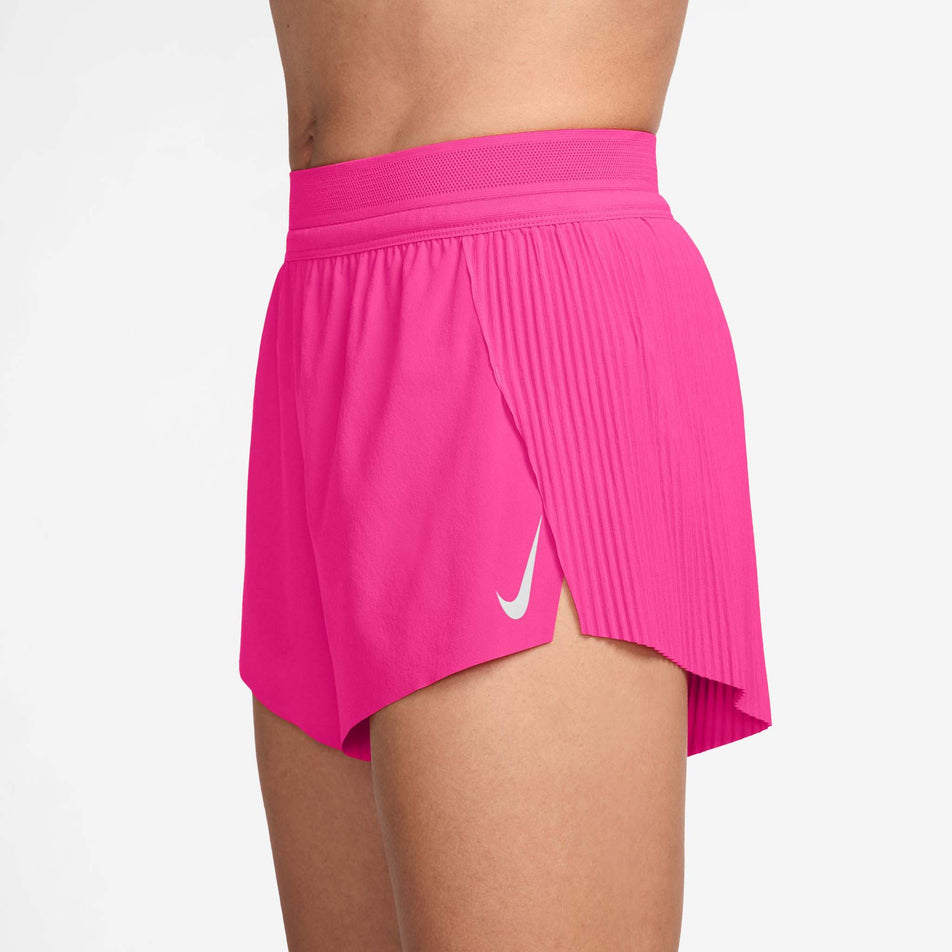 Side view of a model wearing the Nike Women's AeroSwift Dri-FIT ADV Mid-Rise Brief-Lined 3
