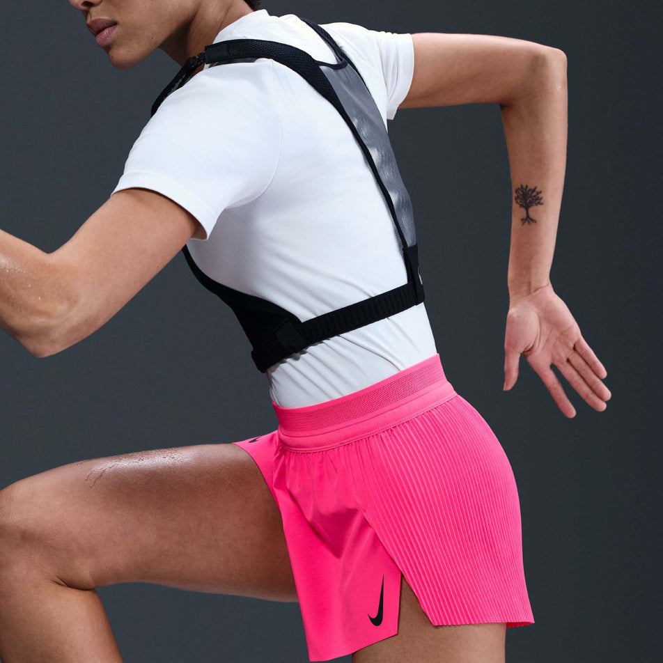 Side view of a model wearing the Nike Women's AeroSwift Dri-FIT ADV Mid-Rise Brief-Lined 3