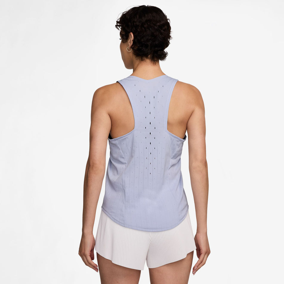 Back view of a model wearing the Nike Women's AeroSwift Dri-FIT ADV Running Singlet in the Ghost/Blue Void colourway. Model is also wearing Nike shorts. (8620116344994)
