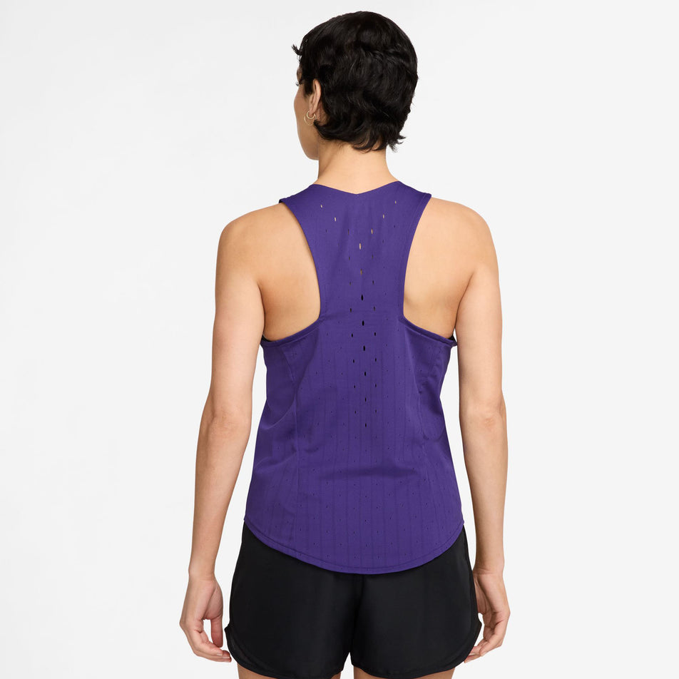 Back view of a model wearing the Nike Women's AeroSwift Dri-FIT ADV Running Singlet in the Court Purple/White colourway. (8692840792226)