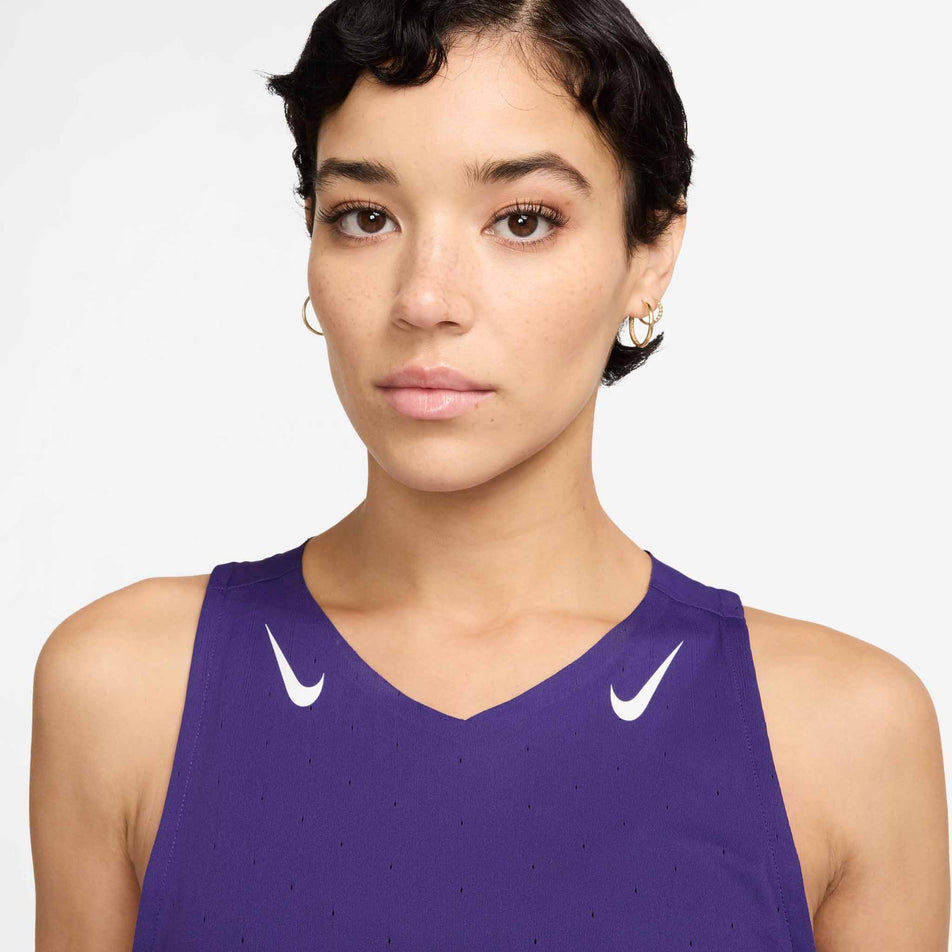 Front view of a model wearing the Nike Women's AeroSwift Dri-FIT ADV Running Singlet in the Court Purple/White colourway. (8692840792226)