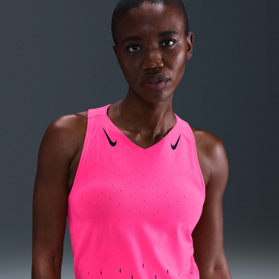 Front view of a model wearing the Nike Women's AeroSwift Dri-FIT ADV Running Singlet in the Hyper Pink/Black colourway. (8692847444130)