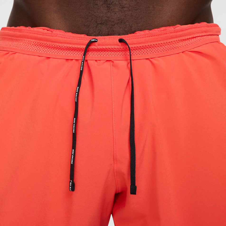 Close-up view of the drawcord on the front of the Nike Men's AeroSwift Dri-FIT ADV 4