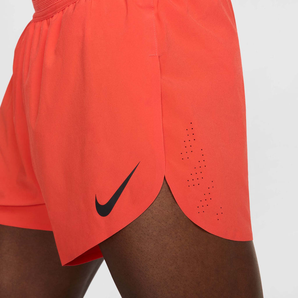 Side view of a model wearing the Nike Men's AeroSwift Dri-FIT ADV 4