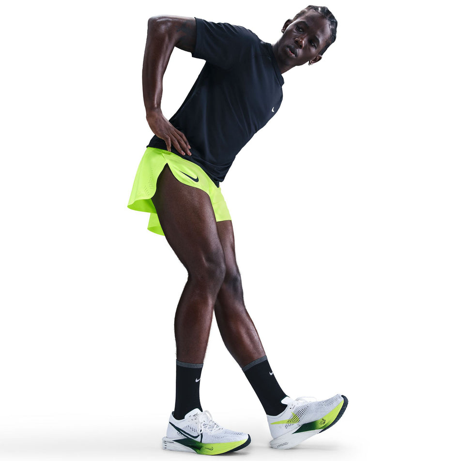 Side view of a model wearing the Nike Men's AeroSwift Dri-FIT ADV 4