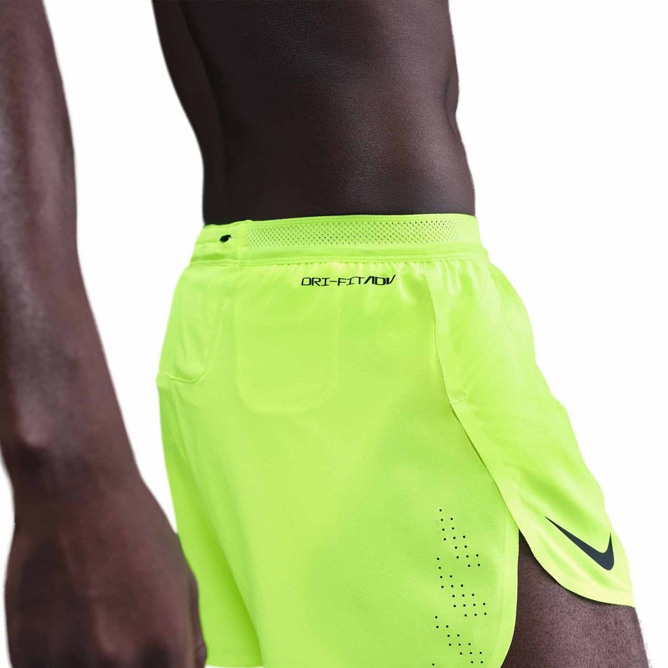 Side view of a model wearing the Nike Men's AeroSwift Dri-FIT ADV 4