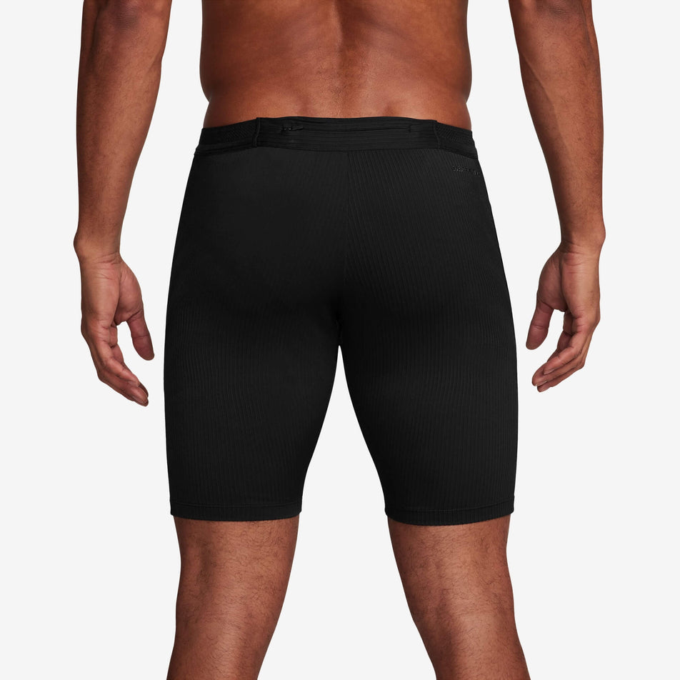 Back view of a model wearing a pair of Nike Men's AeroSwift Dri-FIT ADV Running 1/2-Length Tights in the Black/Summit White colourway (8140202803362)