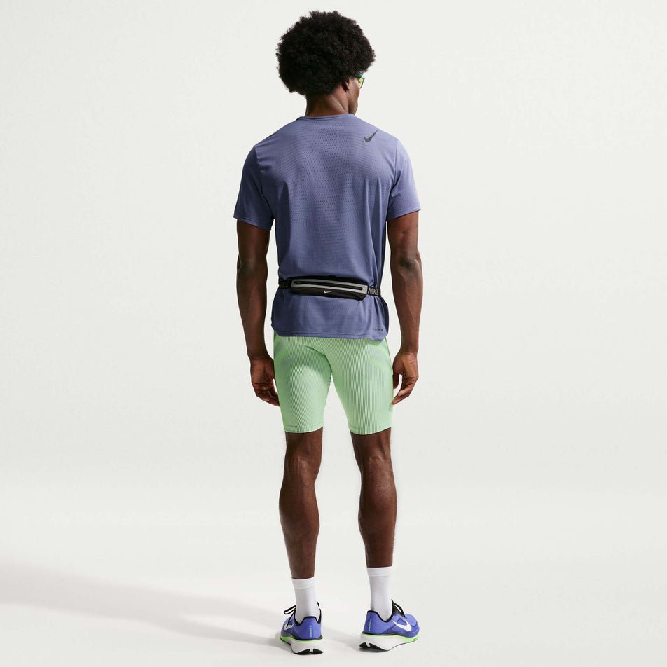 Back view of a model wearing the Nike Men's AeroSwift Dri-FIT ADV Running 1/2-Length Tights in the Lime Blast/Steam/Light Silver/Black colourway.