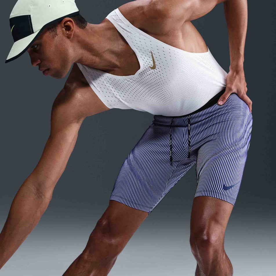 Front view of a model wearing the Nike Men's AeroSwift Dri-FIT ADV Running 1/2-Length Tights in the Vivid Purple/Black/Reflective colourway. (8692967669922)