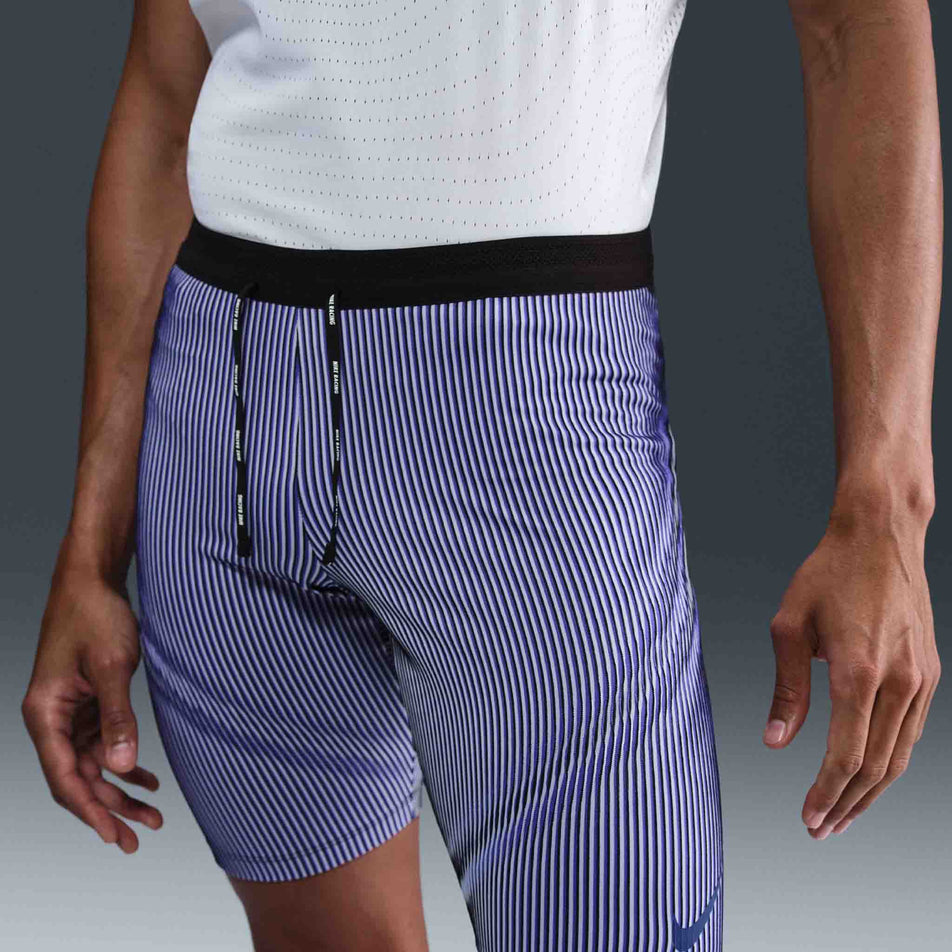Front view of a model wearing the Nike Men's AeroSwift Dri-FIT ADV Running 1/2-Length Tights in the Vivid Purple/Black/Reflective colourway. (8692967669922)