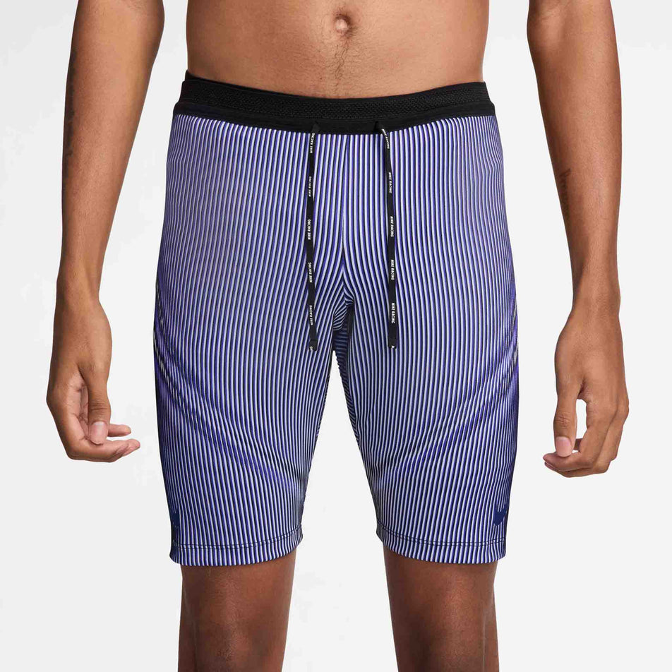 Front view of a model wearing the Nike Men's AeroSwift Dri-FIT ADV Running 1/2-Length Tights in the Vivid Purple/Black/Reflective colourway. (8692967669922)