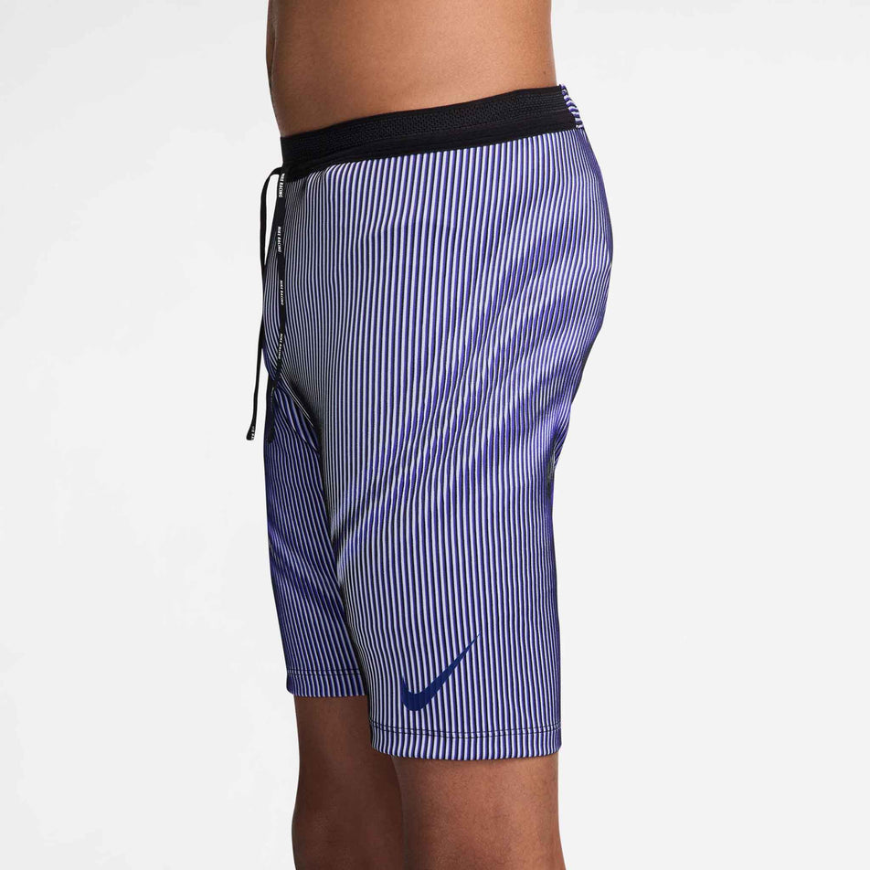 Side view of a model wearing the Nike Men's AeroSwift Dri-FIT ADV Running 1/2-Length Tights in the Vivid Purple/Black/Reflective colourway. (8692967669922)