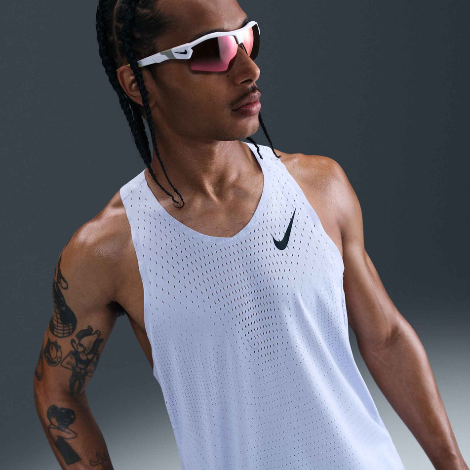Front view of a model wearing the Nike Men's AeroSwift Dri-FIT ADV Running Singlet in the Ghost/Black colourway. (8710799949986)
