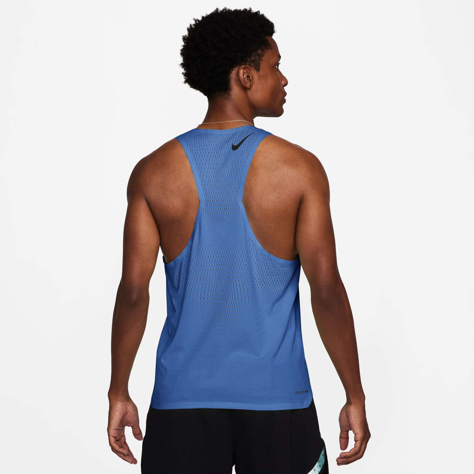 Back view of a model wearing a Nike Men's AeroSwift Dri-FIT ADV Running Singlet in the Comet Blue/Black colourway. Model is also wearing shorts. (8620686508194)