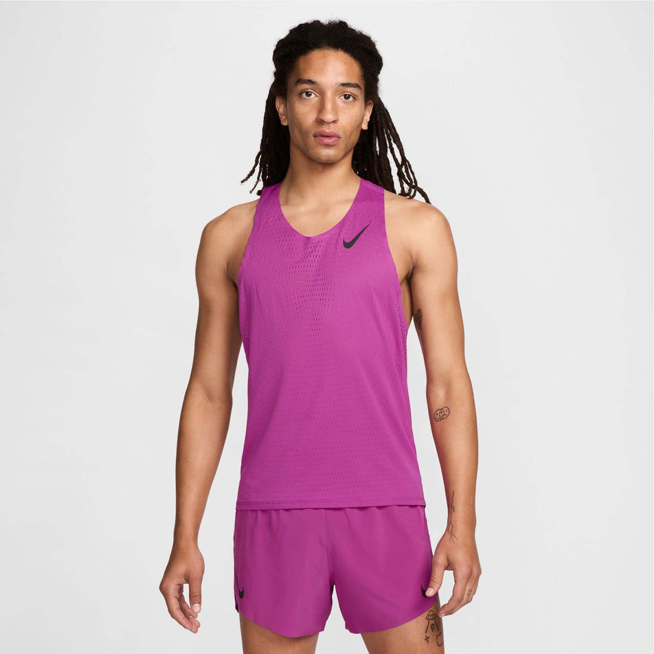Front view of a model wearing a Nike Men's AeroSwift Dri-FIT ADV Running Singlet in the Hot Fuchsia/Black colourway. Model is also wearing Nike shorts. (8497704173730)
