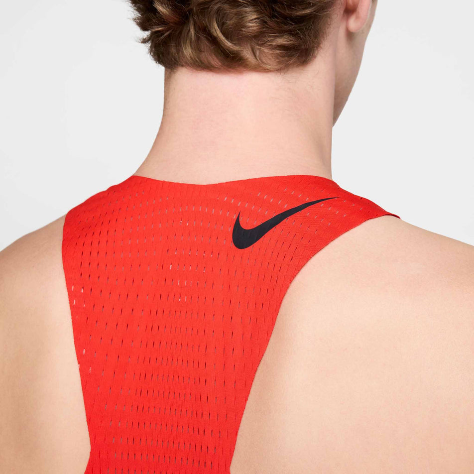 Back view of a model wearing the Nike Men's AeroSwift Dri-FIT ADV Running Singlet in the Light Crimson/Black colourway. (8571124056226)