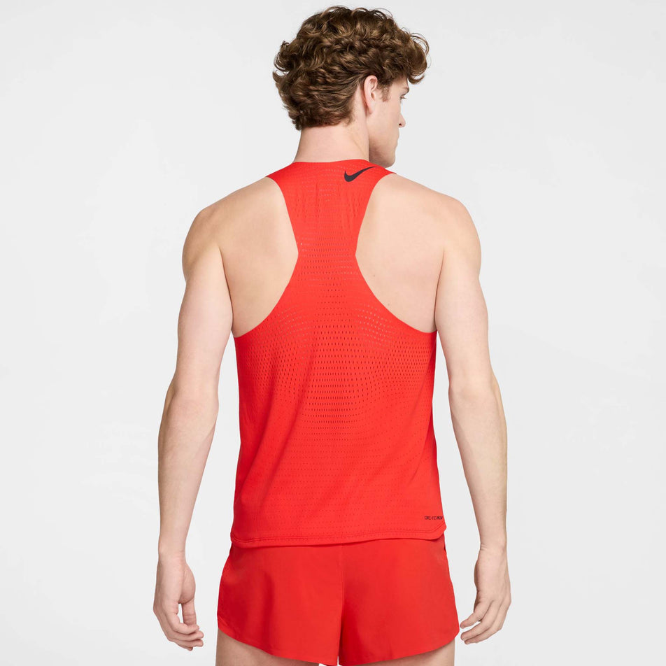 Back view of a model wearing the Nike Men's AeroSwift Dri-FIT ADV Running Singlet in the Light Crimson/Black colourway. (8571124056226)
