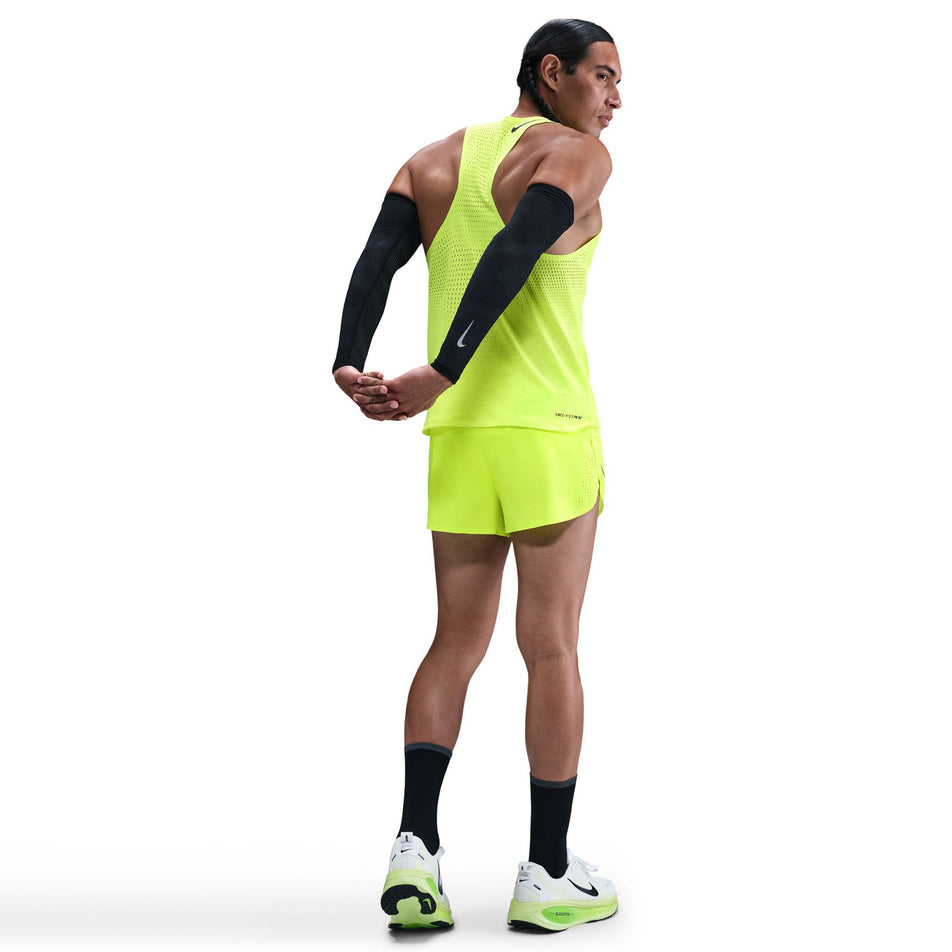 Back view of a model wearing the Nike Men's AeroSwift Dri-FIT ADV Running Singlet in the Volt/Black colourway. (8778164699298)
