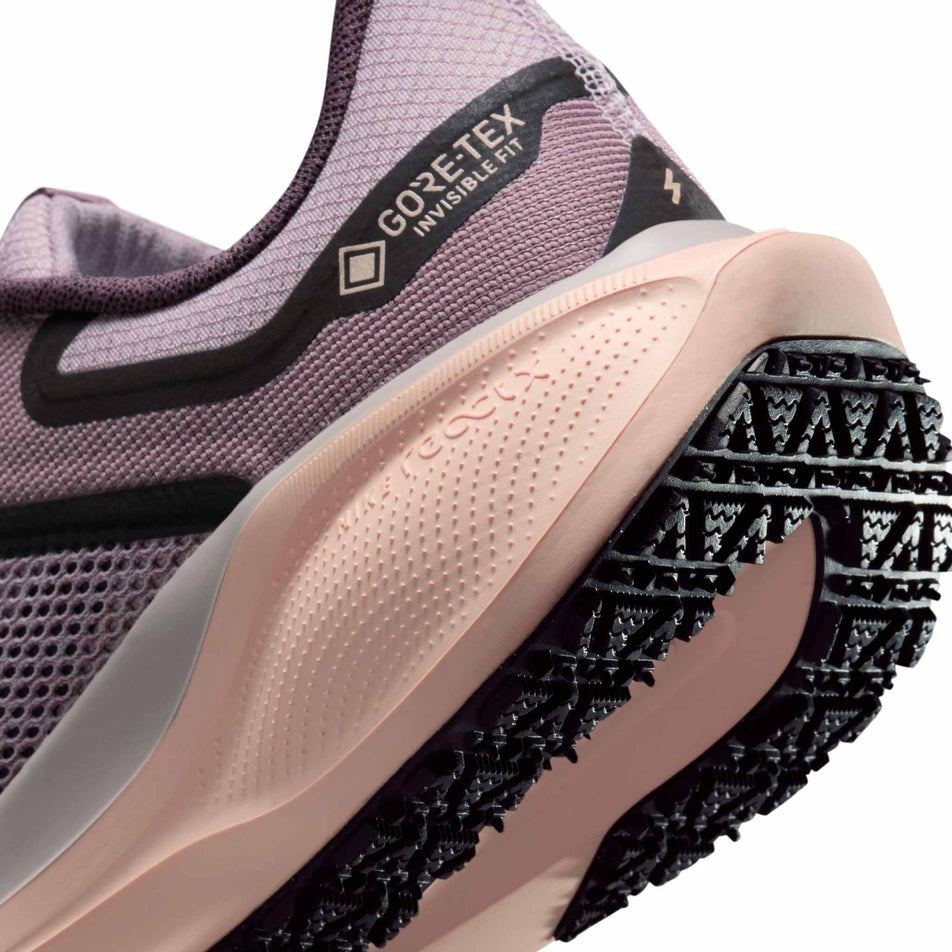 Close-up view of the midsole - outsole - of the left shoe from a pair of Nike Women's Pegasus 41 GORE-TEX Road Running Shoes in the Platinum Violet/Black-Crimson Tint colourway. (8756153417890)