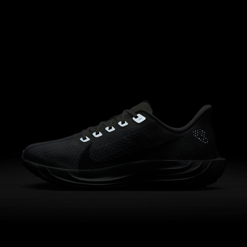 The reflective details on the lateral side of the left shoe from a pair of Nike Women's Pegasus Plus Road Running Shoes in the White/Pure Platinum-Wolf Grey colourway. (8614634029218)