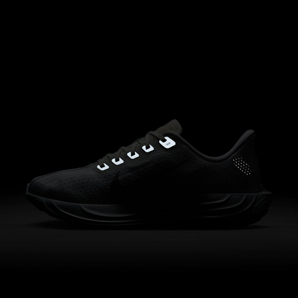 The reflective details on the medial side of the right shoe from a pair of Nike Women's Pegasus Plus Road Running Shoes in the White/Pure Platinum-Wolf Grey colourway. (8614634029218)