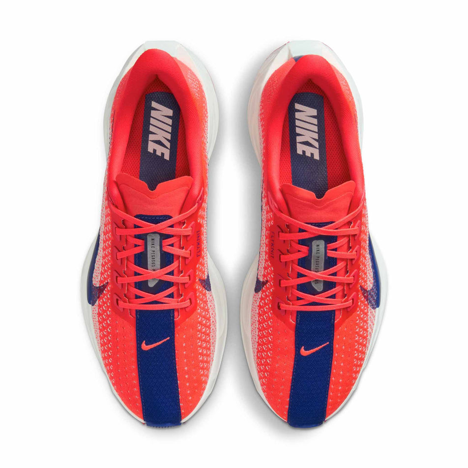 The uppers of a pair of Nike Women's Pegasus Plus Road Running Shoes in the Bright Crimson/Deep Royal Blue-Silt colourway. (8686778581154)