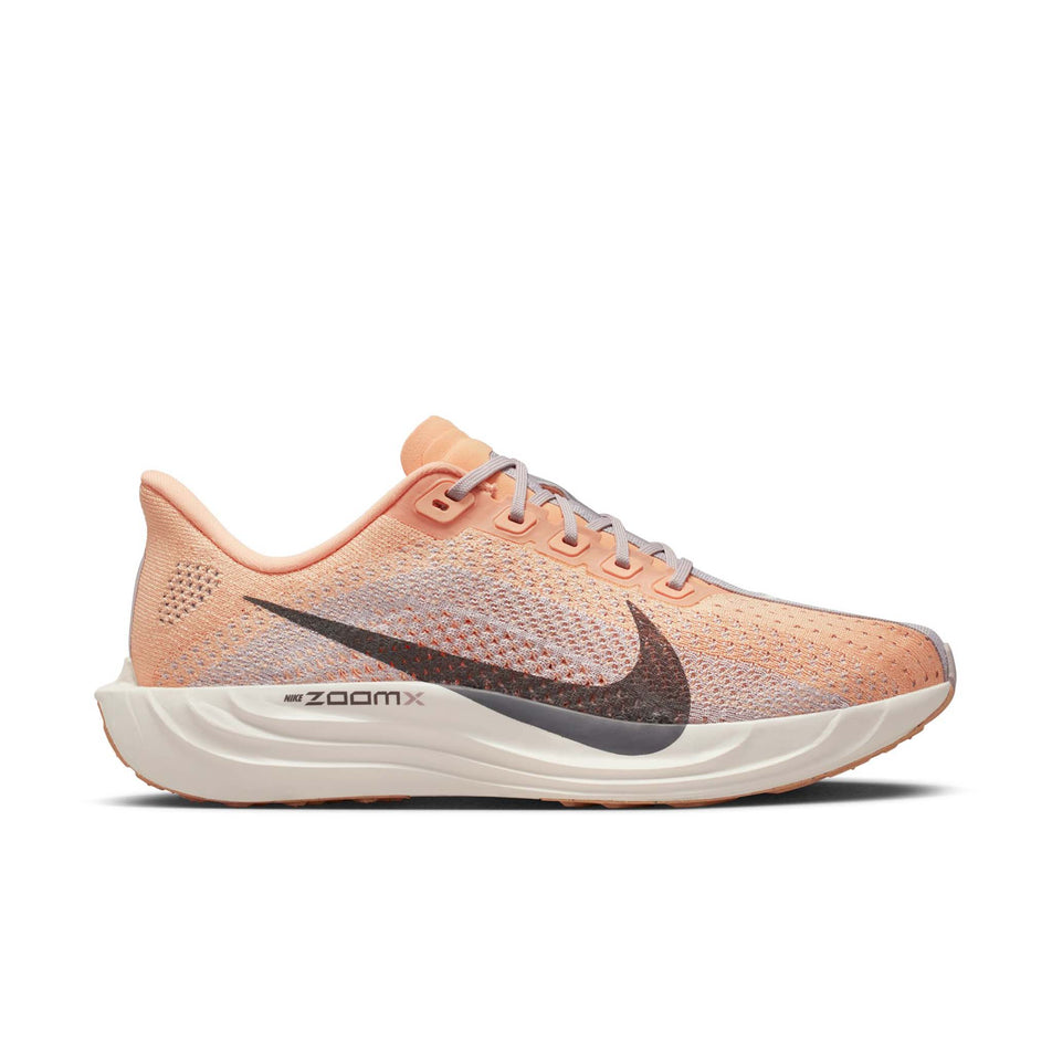 Lateral view of the right shoe from a pair of Nike Women's Pegasus Plus Road Running Shoes in the Orange Chalk/Cave Stone-Platinum Violet colourway.