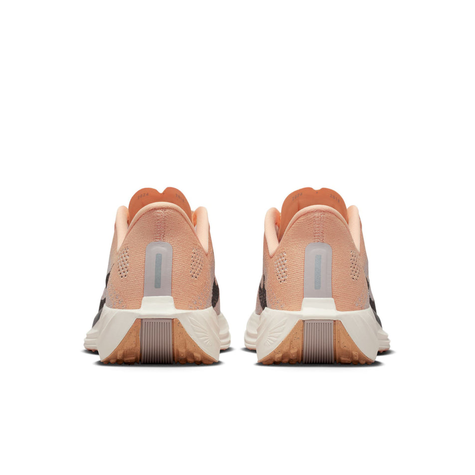 The back of a pair of Nike Women's Pegasus Plus Road Running Shoes in the Orange Chalk/Cave Stone-Platinum Violet colourway.