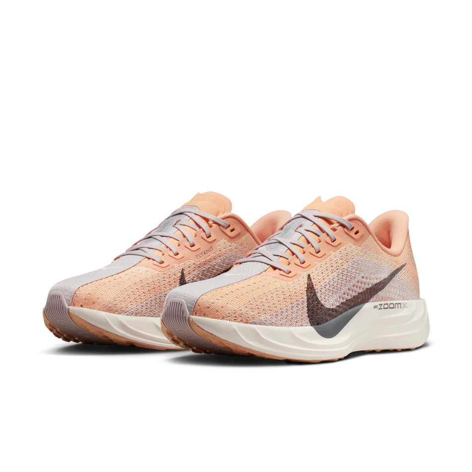 A pair of Nike Women's Pegasus Plus Road Running Shoes in the Orange Chalk/Cave Stone-Platinum Violet colourway.