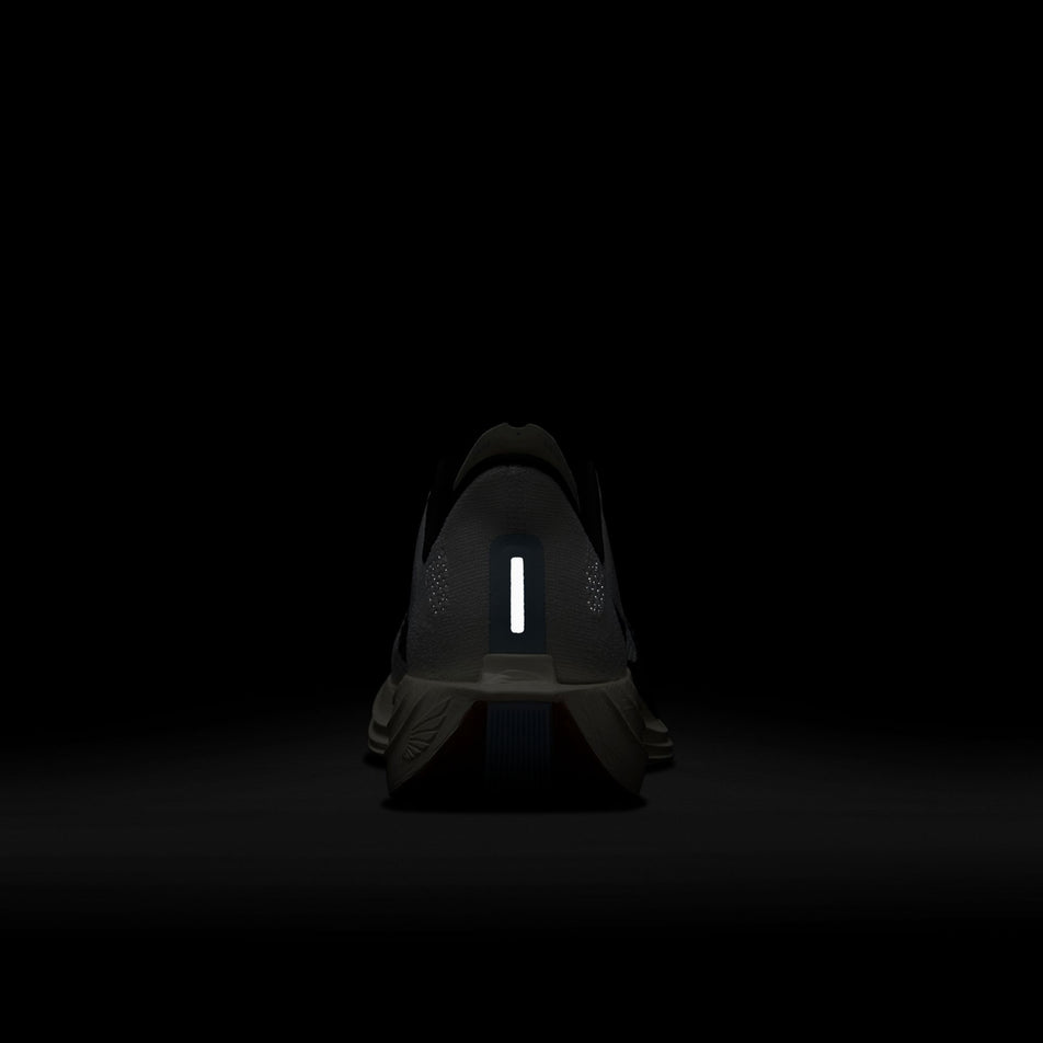 The reflective details on the back of the left shoe from a pair of Nike Men's Pegasus Plus Road Running Shoes in the White/Black-Sail-Blue Tint colourway. (8614356779170)