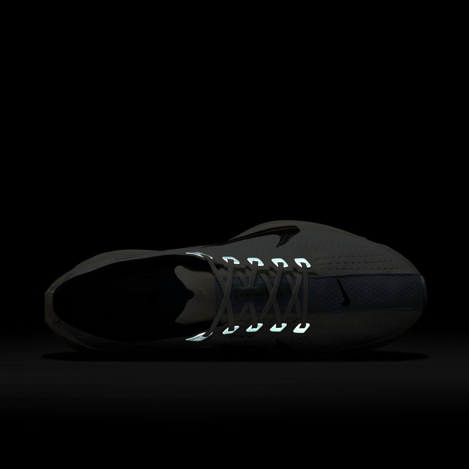 The reflective details on the upper of the left shoe from a pair of Nike Men's Pegasus Plus Road Running Shoes in the White/Black-Sail-Blue Tint colourway. (8614356779170)