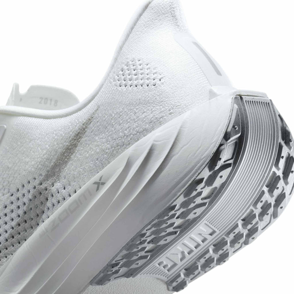 Close up of the midsole of the left shoe from a pair of Nike Men's Pegasus Plus Road Running Shoes in the White/Pure Platinum-Wolf Grey colourway. (8683735351458)