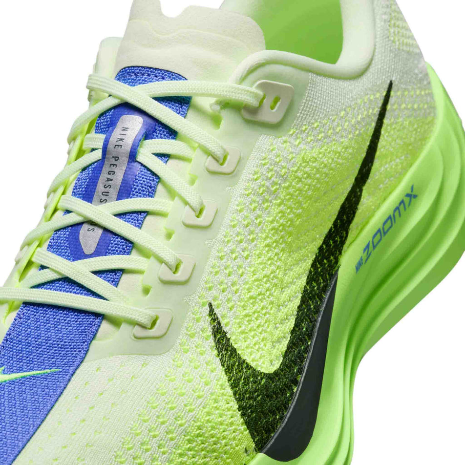 Close-up view of the upper of the left shoe from a pair Nike Men's Pegasus Plus Road Running Shoes in the Volt Ice/Black Spruce-Volt Tint colourway.