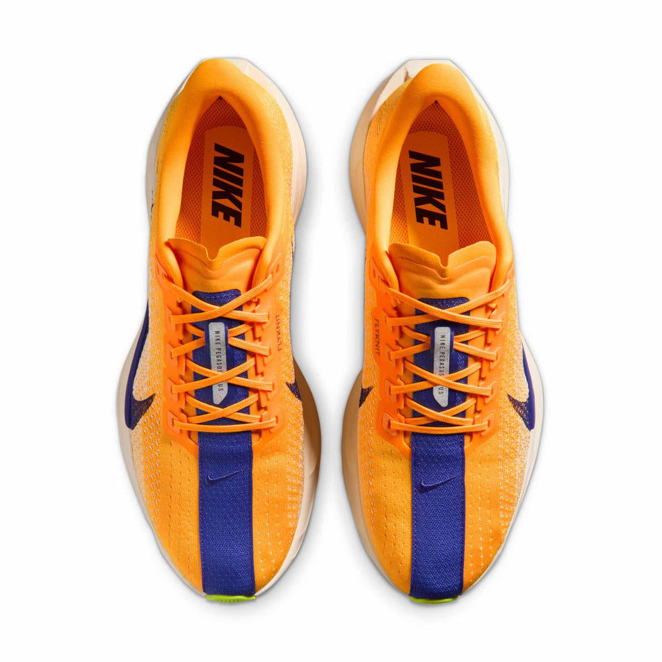 The uppers of a pair of Nike Men's Pegasus Plus Road Running Shoes in the Laser Orange/Indigo Burst-Alabaster-Sail colourway.